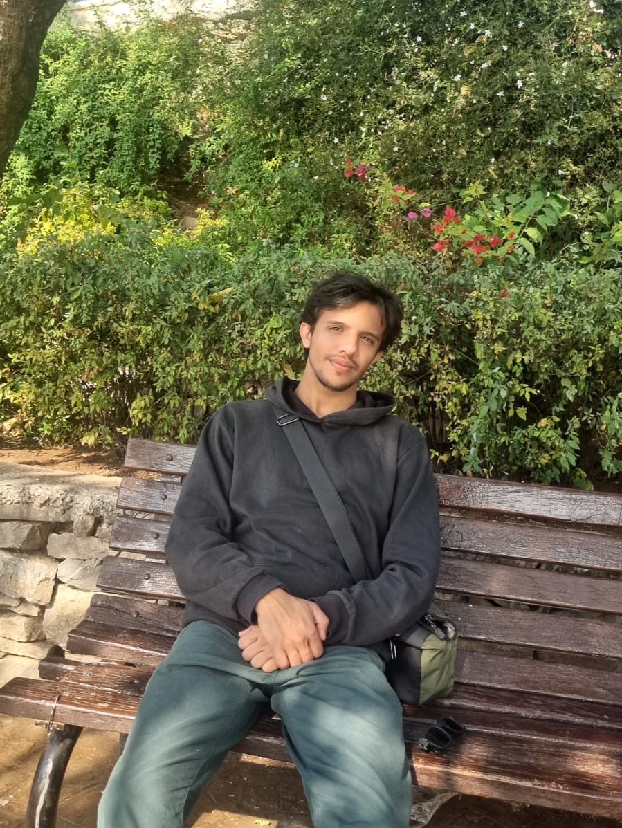 Illiyin sitting on a bench outdoors